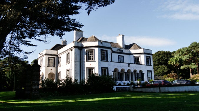 A photograph which features Cushendun's Glenmona House.